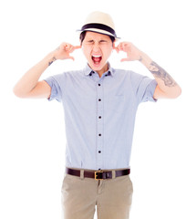 Young woman standing with fingers in her ears
