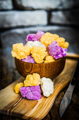 Colorful cauliflower on rustic background