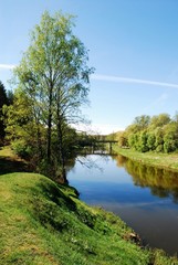 Summer river with bright blue sky and clouds