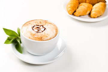 large cup of coffee and croissants on a plate