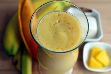 Yellow smoothie made with mango, bananas, pineapples and tofu