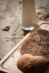 Several slices of Bread wheat and wooden chopping board