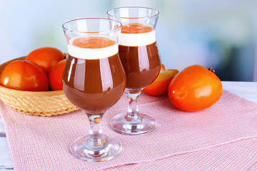 Dessert of chocolate and persimmon on table on light background