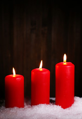 Burning candles on wooden background