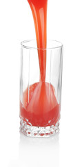 Juice pouring into glass isolated on white
