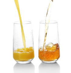 Juice pouring into glass isolated on white