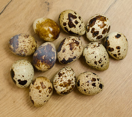 Few quail eggs on wooden tabletop.