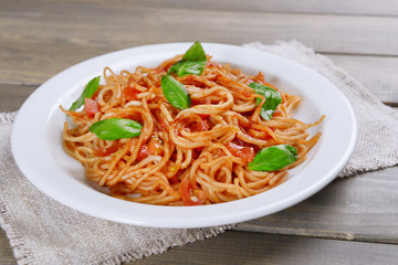 Pasta with tomato sauce on plate on table close-up