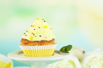 Tasty cup cake with cream, close up