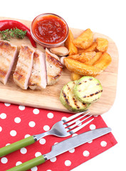 Grilled steak with fried potato pieces and grilled vegetables