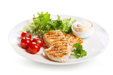 plate of grilled chicken breast with vegetables