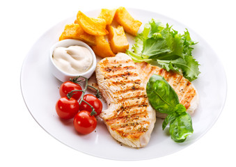 plate of grilled chicken breast with vegetables