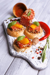 Composition of tasty sandwiches with salami sausage, basil leaf