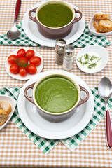 Tasty soup in saucepans on tablecloth, close up