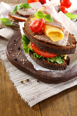 Delicious sandwiches with meet on table close-up