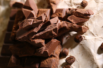 Chopped bar of chocolate on light background