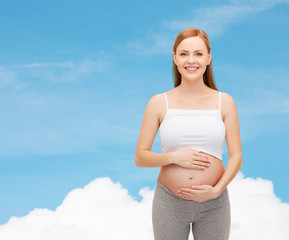 happy future mother touching her belly