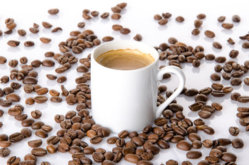 Coffee beans around a cup