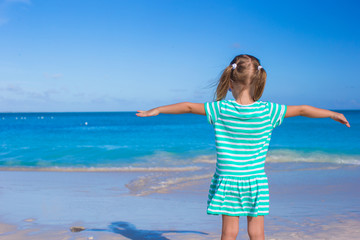 Fototapeta na wymiar Adorable little girl at white beach during summer vacation