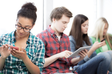 students looking into devices at school