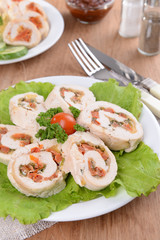 Delicious chicken roll on plate on table close-up