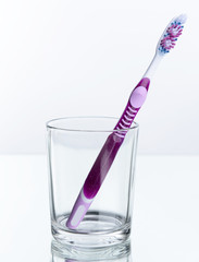 Toothbrush in glass isolated on white