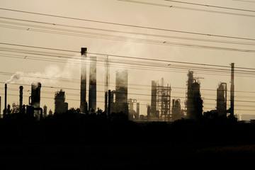 view of oil crude refinery against the sunlight