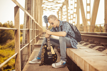musician at railway bridge
