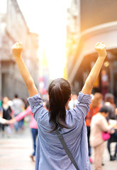 cheering woman open arms at street