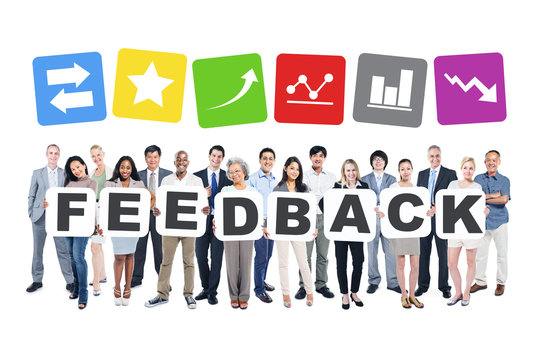Group Of Business People Holding The Word Feedback