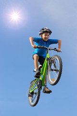 Boy jumping on bike