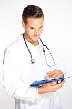 Portait Of Young Male Doctor With Stethoscope And Clipboard