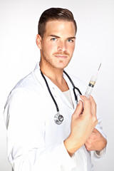 Portrait of young male doctor holding syringe with injection