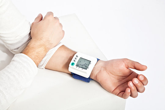 Photo of young man&rsquo;s hand measuring his blood pressure
