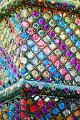 traditional color lamp hanging from a stucco wall