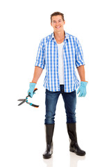 young man holding garden shears