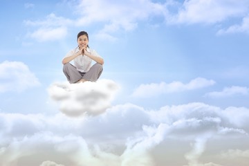 Composite image of businesswoman sitting cross legged with hands