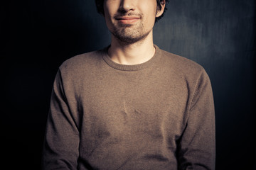 Obraz premium Happy young man against black background