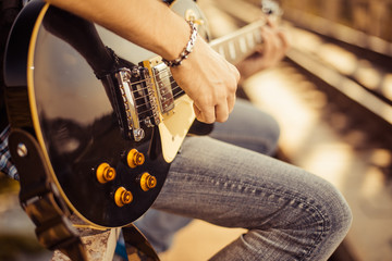 guitar player playing song outdoor