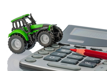 tractor, red pen and calculator