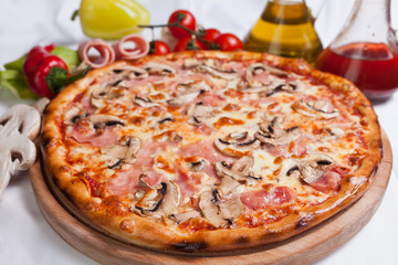 Pizza with mozzarella, ham and mushrooms