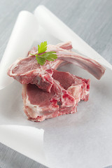 Raw fresh lamb cutlet in backing paper