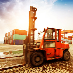 forklift handling the container box at dockyard with beautiful s