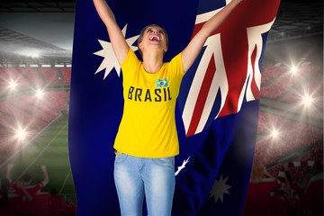 Excited football fan in brasil tshirt holding australia flag