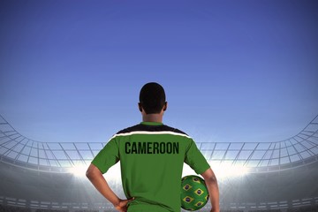 Cameroon football player holding ball