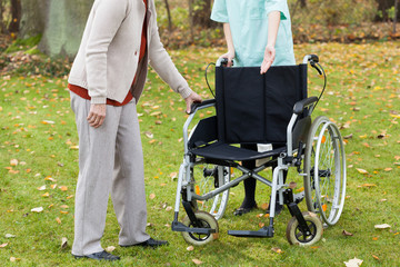 Disabled trying to sit on wheelchair