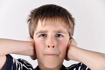 Young boy covering his ears with hands