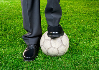 Businessman playing with soccer ball
