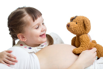 kid girl telling a tale to baby in pregnant mother's belly