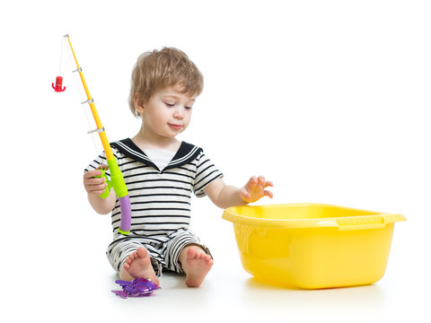 Cute child boy playing with toy rod